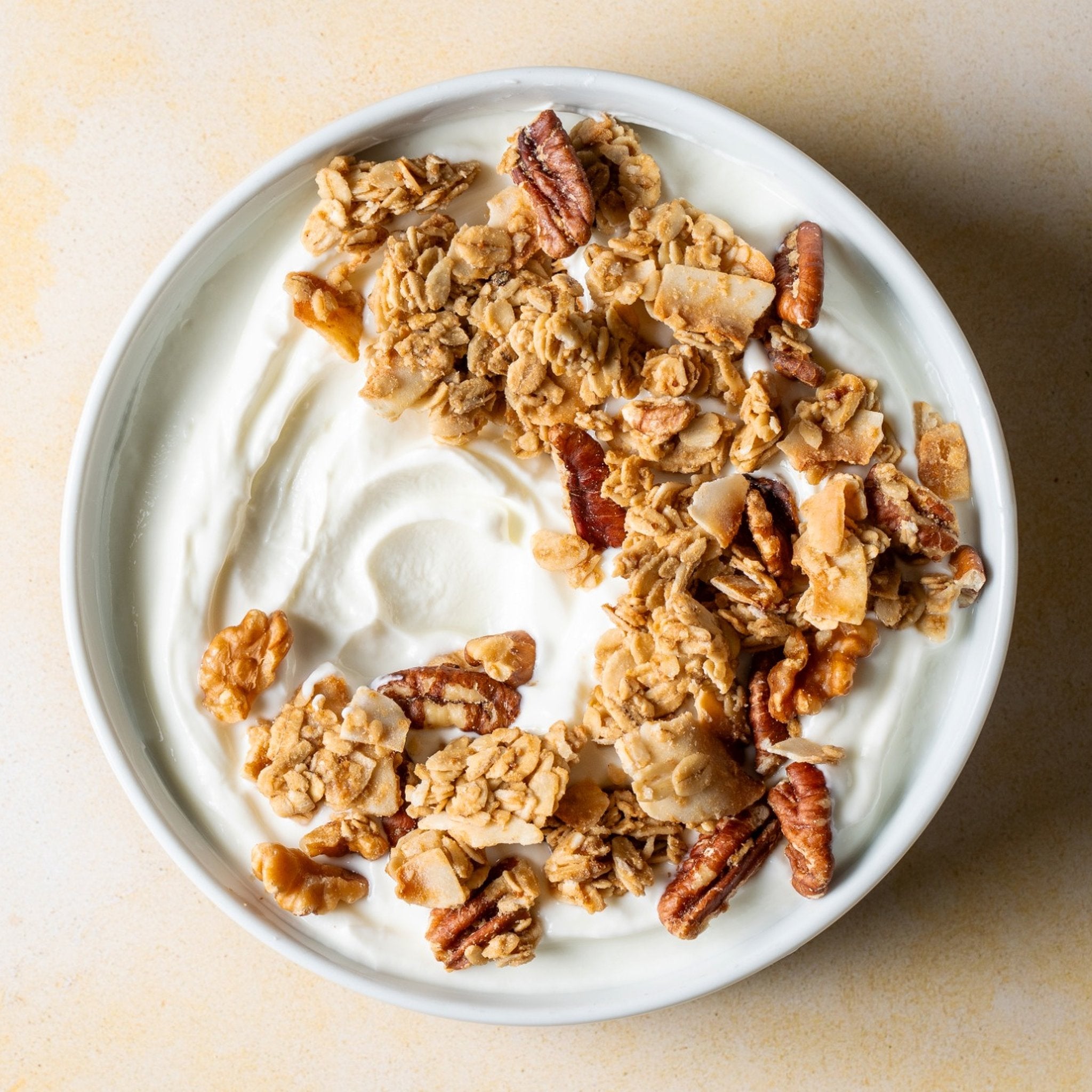 Coconut walnut granola in a bowl with yogurt — gluten free, no seed oils